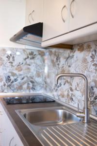 a kitchen with a sink and a counter top at Liogerma Apartments in Pefkochori +95 photos