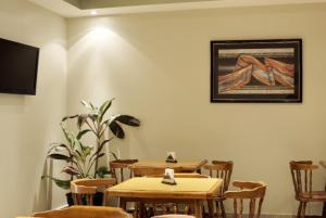 a restaurant with two tables and chairs and a picture on the wall at Blanro Hotel in Buenos Aires