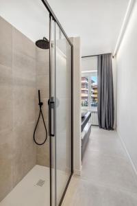 a walk in shower with a glass door at Casa Matilde in Baveno +65 photos