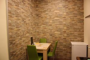 a dining room with a table and green chairs at Pasettistraße 31 in Vienna