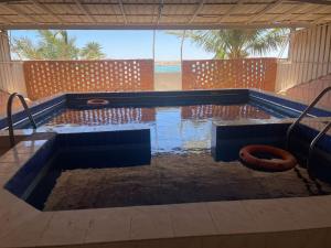 a pool of water with a swimming pool at أصداء البحر للشقق المخدومة in Yanbu