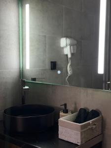 a bathroom with a bath tub and a mirror at Joannas Airport Luxury Rooms in Artemida +26 photos