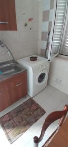 a small kitchen with a sink and a washing machine at Casamare in Roseto degli Abruzzi +11 photos