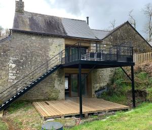 a house with a staircase on the side of it at Gîte du Nid Beau Duplex tout confort, entouré de verdures, piscine chauffée de mi-mai à mi-sept in Noyal-Muzillac