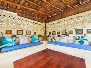 a room with blue and white pillows on benches at Zanzicrown in Nungwi