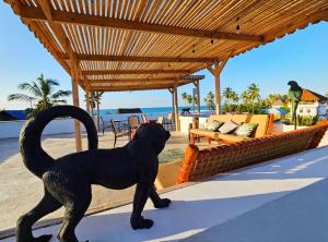 a statue of a black dog standing on a patio at Zanzicrown in Nungwi