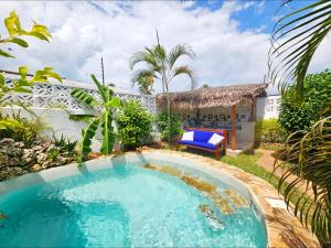 a swimming pool in the yard of a house with a villa at Zanzicrown in Nungwi