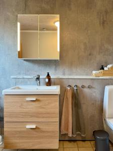 a bathroom with a sink and a mirror at Family home in Älmhult +18 photos