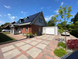 a brick house with a solar roof on a patio at Family home in Älmhult
