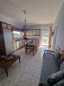 a living room with a couch and a table at Emporios Mansion in Emporeiós +43 photos