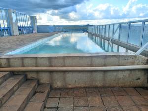 a swimming pool on the side of a building at NNET Studio Apartments in Nairobi