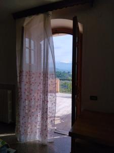an open door to a balcony with a curtain at Villa vista La Majella in Chieti +23 photos