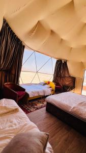 a room with three beds in a tent at Wadi Rum Luxure desert Camp in Wadi Rum +84 photos