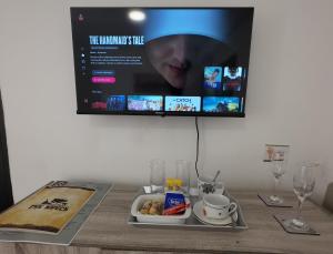 a tray of food on a table with a tv at Grace Avenue Bungalow in Port Edward