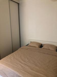 a bed with two pillows on it in a bedroom at Cozy&Quiet Apartment in City Center near Park&Playground in Klaipėda +8 photos