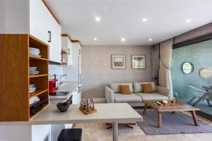 a living room with a couch and a table at Marje Villas Bodrum in Bodrum City