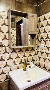 a bathroom with a sink and a mirror at Wadi Rum Luxure desert Camp in Wadi Rum