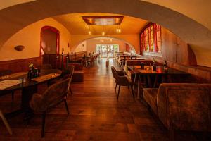 a restaurant with tables and chairs in a room at Alte Schlossbrauerei in Mirow