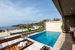 a pool on the roof of a house with a view at Marje Villas Bodrum in Bodrum City