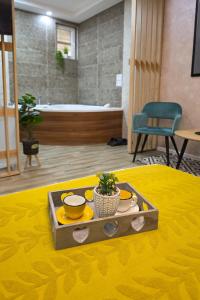 a table with a tray of food on top of a room at VANIMI lux apartmani in Kikinda