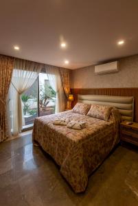 a bedroom with a large bed and a window at Marje Villas Bodrum in Bodrum City