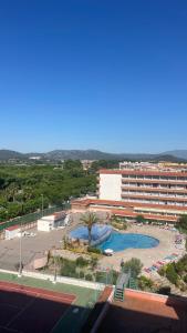 a resort with a pool and a large building at Maravilloso apartamento Delux in Blanes +37 photos