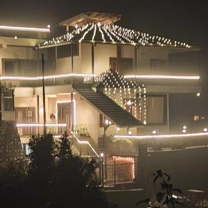 a building with a lot of lights on it at night at Eldora - Luxury of Leisure in Nainital