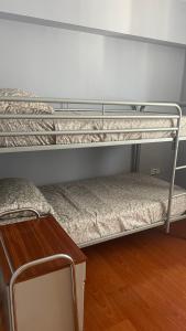 two bunk beds in a room with a table at Maravilloso apartamento Delux in Blanes