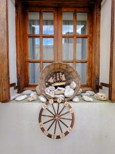 a window with a basket and rocks on a table at ASPRO house in Chora Folegandros