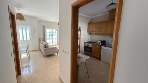 een keuken met een deur naar een woonkamer bij BS House - Manta Rota in Manta Rota