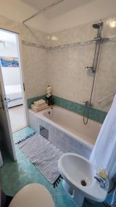 a bathroom with a bath tub and a sink and a bath tub at Center of Rovinj, sea view apartment in Rovinj