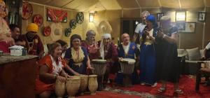 a group of people in a room with drums at Erg Sahara camp in Adrouine