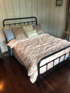 a bed with pillows and a blanket on it at Quiet Harrisburg home in Harrisburg