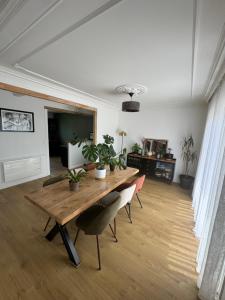 a dining room with a wooden table with plants on it at Maison 3ch proche circuit 24h et boulerie jump in Saint Pavace