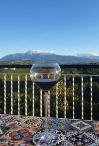 a glass of wine sitting on top of a table at Villa vista La Majella in Chieti