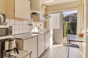 a kitchen with a sink and a counter top at Appartement in Cadzand