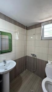 a bathroom with a sink and a toilet and a shower at Vila Bedro in Sarandë +24 photos