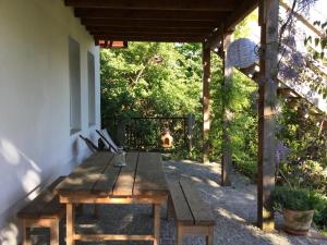a wooden table sitting on the side of a patio at Apartament u Zosi in Wisełka