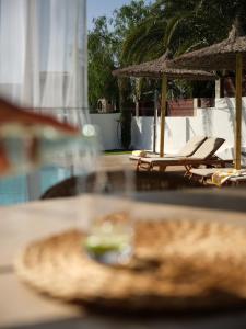 a table with two lounge chairs and a sandwich at Unique Homes Lajares - adults only in Lajares