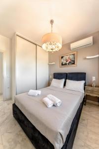 a bedroom with a large bed with two towels at Anastasia Suite Of The Sun&Sea, By Idealstay Experience in Kokkíni Khánion
