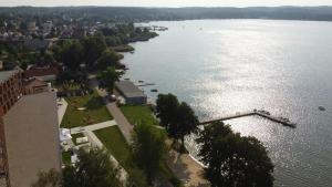 an aerial view of a river with trees and buildings at KAMERALNY przy promenadzie - pokoje in Charzykowy