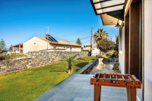 a bench sitting on the side of a house at Anastasia Suite Of The Sun&Sea, By Idealstay Experience in Kokkíni Khánion