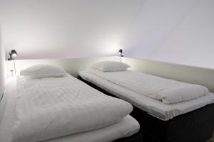 Postel nebo postele na pokoji v ubytování GEG Hotel
