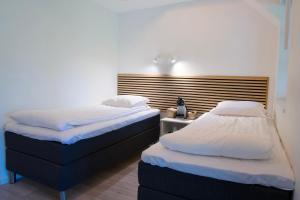 Postel nebo postele na pokoji v ubytování GEG Hotel