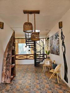 a room with a spiral staircase in a house at Zanzicrown in Nungwi