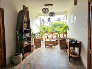 a living room with a table and some plants at Zanzicrown in Nungwi
