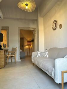 a living room with a bed and a table at Arch Residence, studio 1, Apothika in Katarráktis