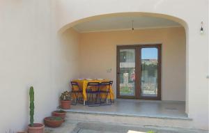 a yellow table and chairs on a patio at Awesome Home In Malamuri With Wifi in Budoni