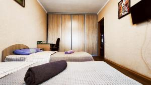 a room with two beds and a table with a tv at Василя Стуса 10 City Rooms in Bila Tserkva
