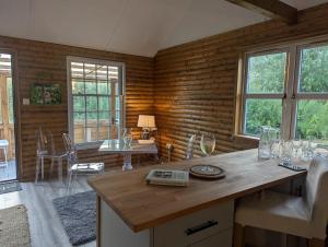 a room with a table and chairs and a dining room at The Lodge at Tetley in Crowle